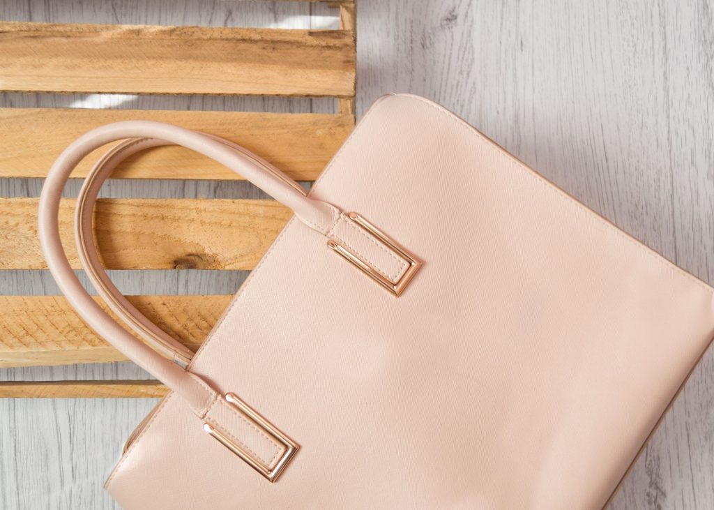 a pink purse on a wooden pallet