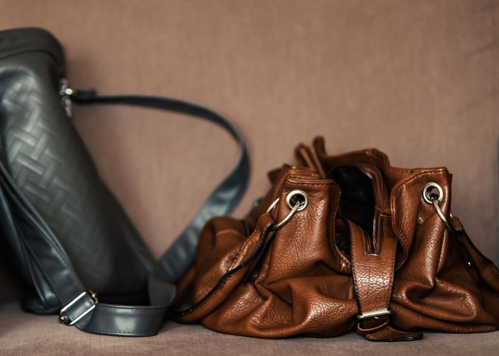 a brown purse next to a black purse