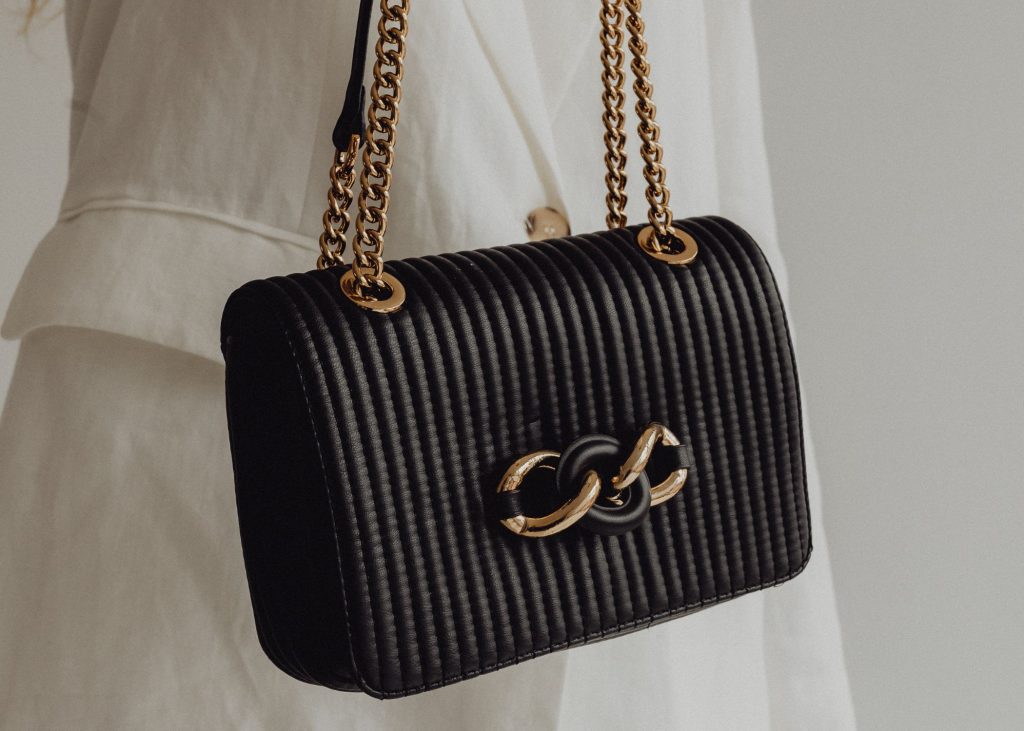 a black bag with gold chains