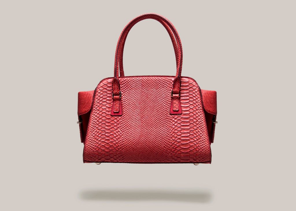 a red handbag with a white background